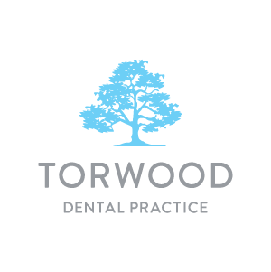 Logo of Torwood Dental Practice featuring a blue tree and text.