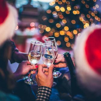 Celebrating Christmas holidays with a group of friends, toasting with champagne