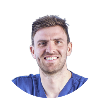 Andrew Fleming wearing blue scrubs, smiling, portrait photograph suitable for Clyde Munro dental team page