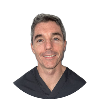 Anthony James, a dental professional with gray hair, wearing dark scrubs, smiling against a light background, suitable for clinical staff profiles and about pages