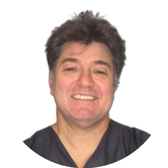 Portrait of Dino-Loizides wearing dark scrubs, smiling at the camera, professional dental staff headshot suitable for Clyde Munro Dental branding and team pages