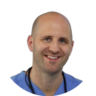 Portrait of Duncan Weir wearing blue scrubs with a shaved head, smiling, suitable for Clyde Munro dental practice staff bios and pages