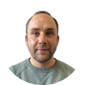 Portrait of Scott-Tulloch wearing a grey-green sweater, featuring a light beard and a calm expression, suitable for a dental practice staff page on Clyde Munro