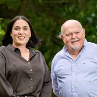 Louise Reeves and Jim Hall stand together outdoors as Clyde Munro announces Reeves’ appointment to lead its next chapter.
